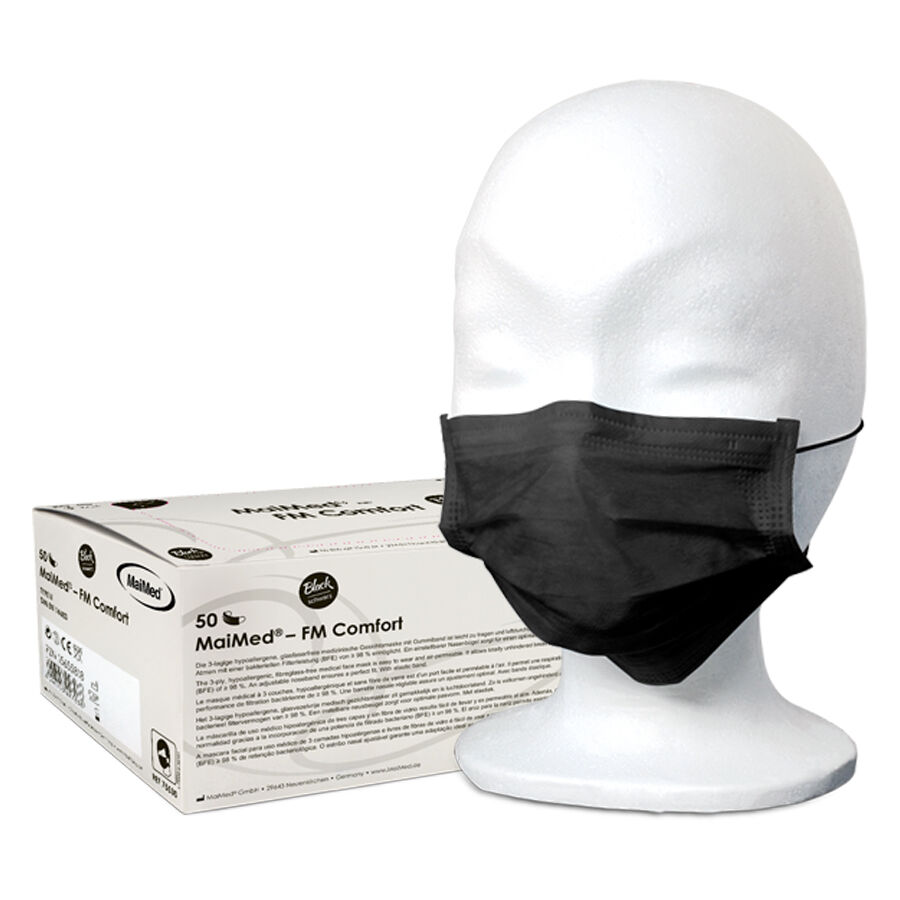 Masque facial noir MaiMed Comfort Masque facial jetable noir MaiMed sur tête de mannequin blanc avec emballage en arrière-plan