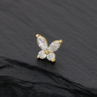 Embout papillon en or avec pierres de moissanite claires sur fond noir