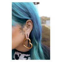 Twisted Chain Clicker en or à l'oreille avec des cheveux bleus en arrière-plan