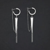 Boucles d'oreilles argentées triangle avec chaînes Boucles d'oreilles argentées avec pendentif triangulaire et chaînes sur fond noir