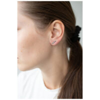 Femme aux cheveux bruns portant un élégant clou d'oreille en cristal argenté