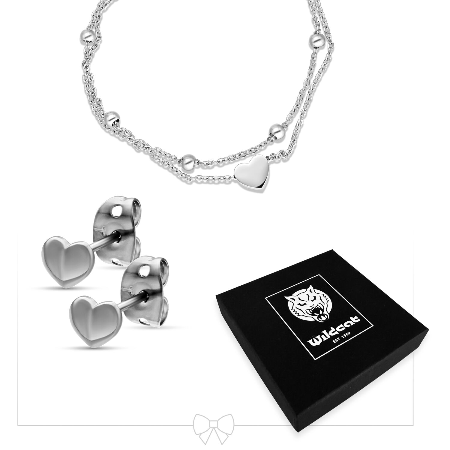 Ensemble bracelet cœur et boucles d'oreilles en acier inoxydable Bracelet cœur en argent avec double chaîne et boucles d'oreilles cœur à côté d'une boîte cadeau noire