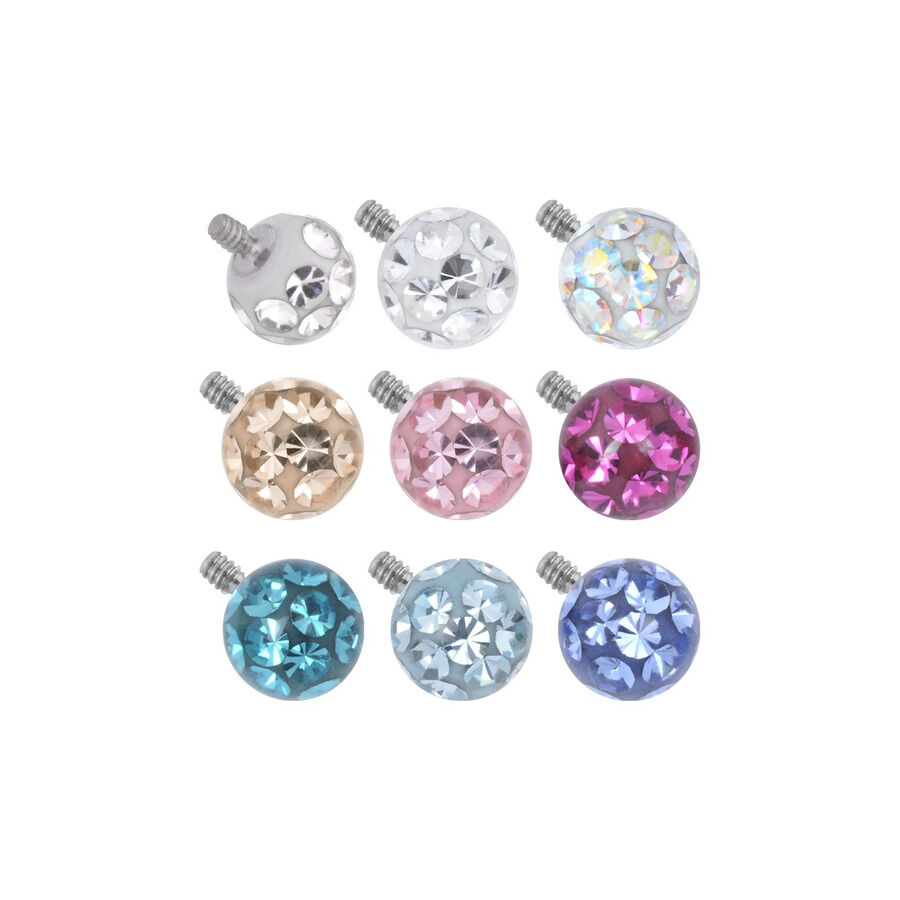 Neuf embouts ronds multicolores avec cristaux sur fond blanc