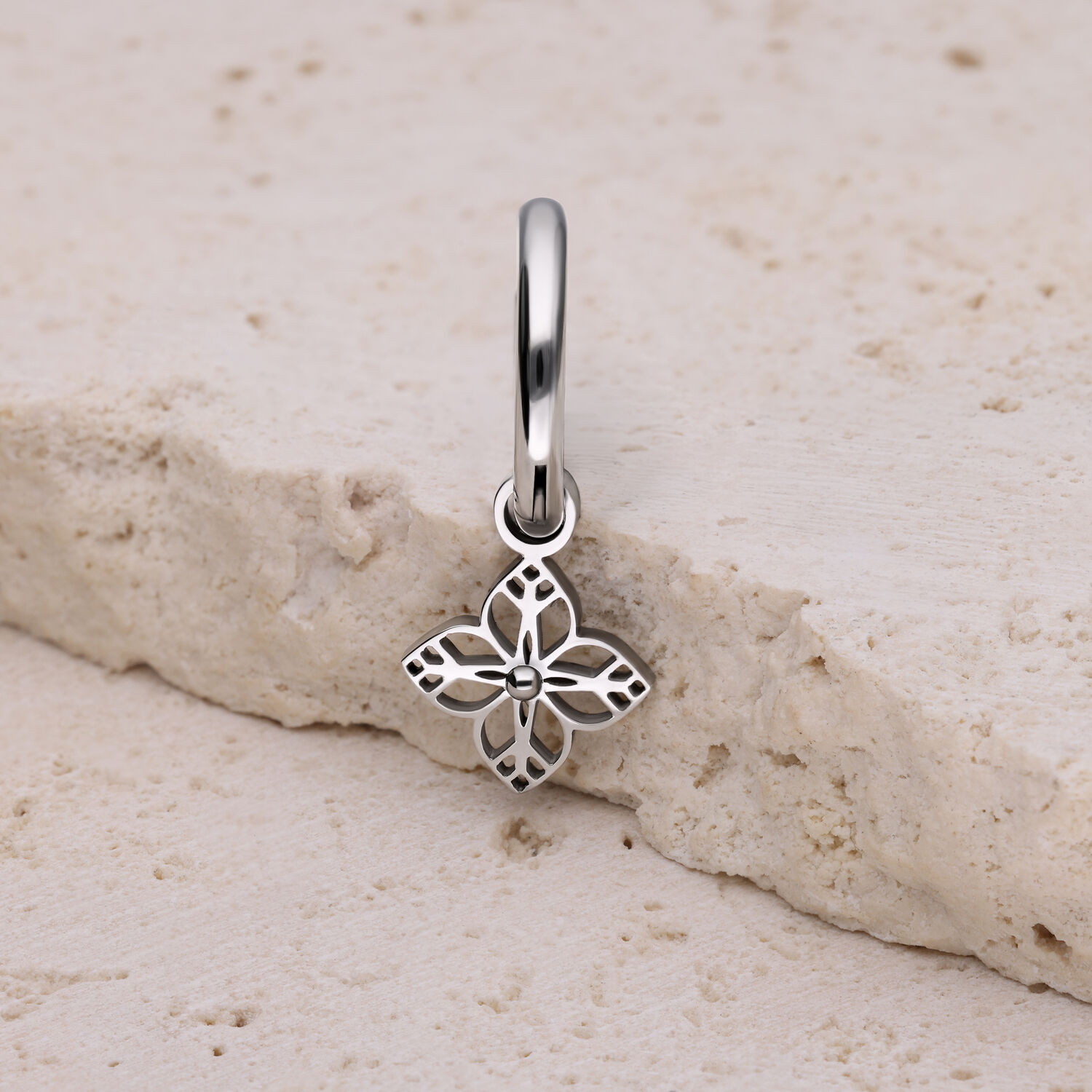 Boucle d'oreille pendentif fleur argentée Boucle d'oreille argentée avec pendentif en forme de fleur sur pierre claire