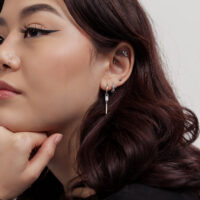 Petites boucles d'oreilles en cristal à l'oreille Femme avec petites boucles d'oreilles carrées en cristal sur fond blanc