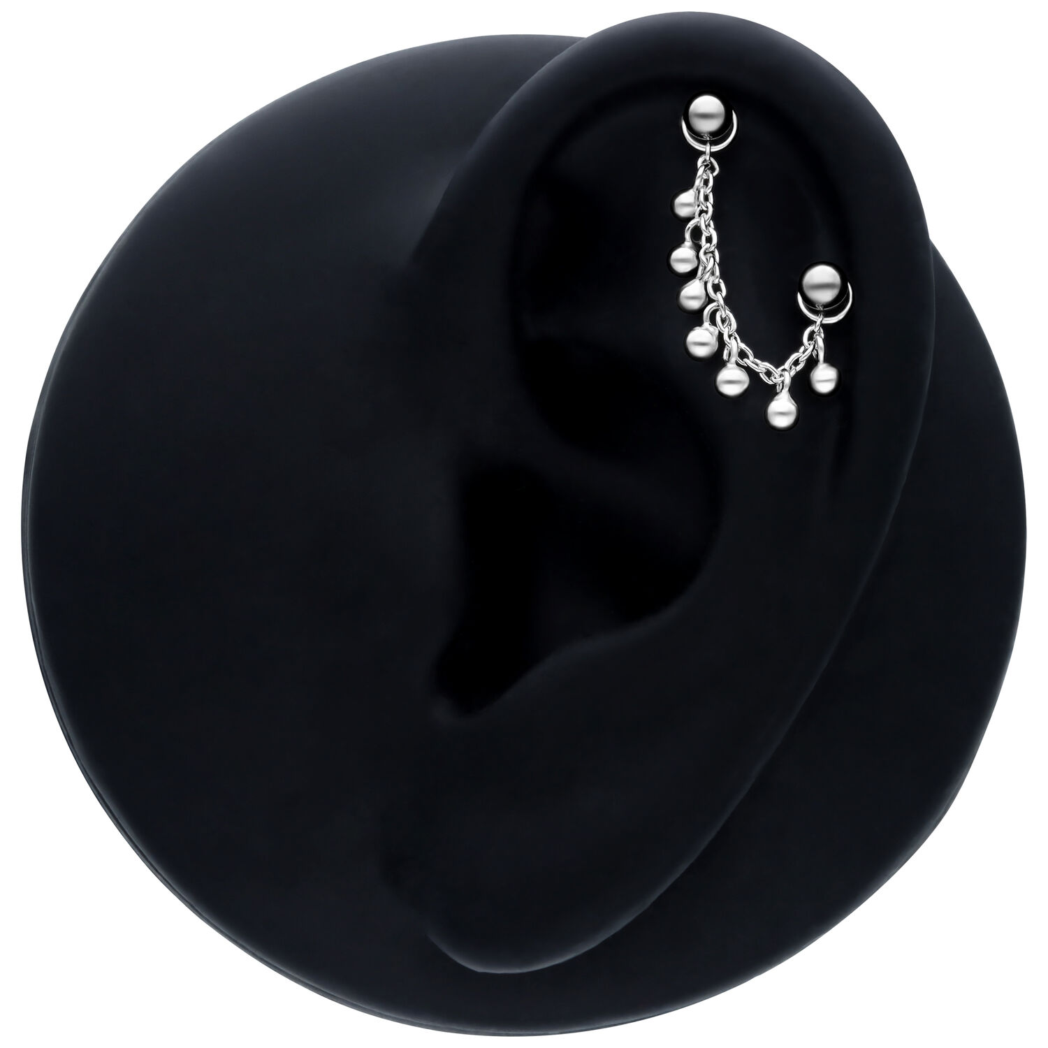 Chaîne de piercing noire avec petites perles, longueur 20mm, sur un modèle d'oreille