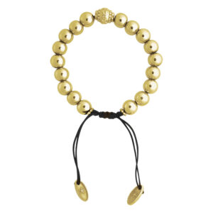 Bracelet doré avec perles rondes et bande noire sur fond blanc