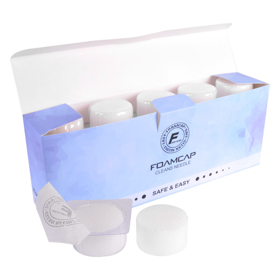 Caps en mousse blanches pour accessoires de tatouage Caps en mousse blanches dans un emballage bleu, ouvert sur fond blanc