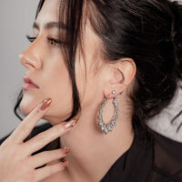 Boucles d'oreilles Sunflower tendance en argenté Femme aux cheveux noirs portant des boucles d'oreilles Sunflower argentées