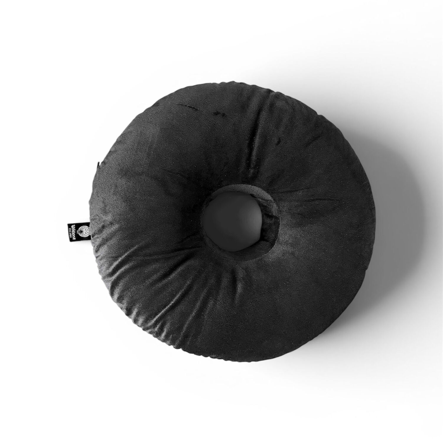 Coussin rond noir pour piercing en polyester Coussin rond noir avec trou au centre sur fond blanc