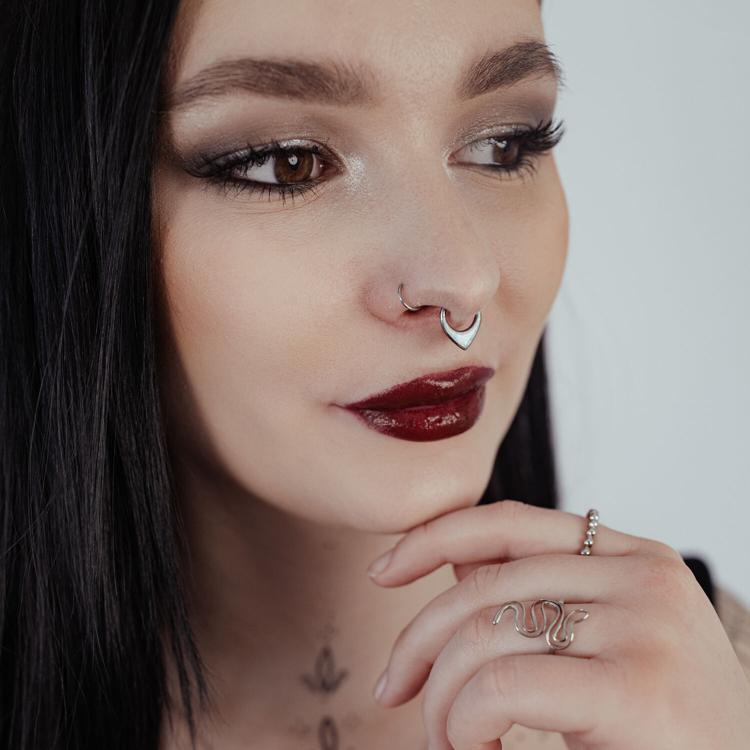 Clicker de Septum Chunky Opale en Argent Femme aux cheveux noirs portant un clicker de septum en argent avec opale sur fond clair